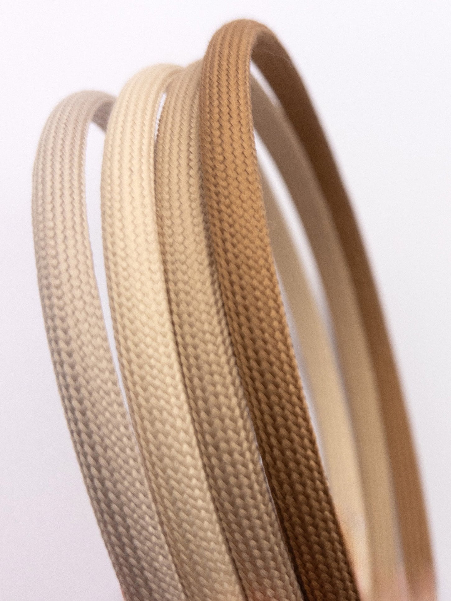 Close up photo of Heliums headbands in ash blonde, beige, medium blonde and dark blonde colors.