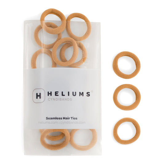 Heliums small seamless hair ties in gold, shown in a pack and individually